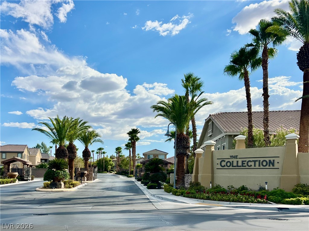 151 Short Ruff Way Las Vegas, NV 89148 - Photo 2 of 17 "The Collections" Gated Subdivision in Rhodes Ranch. Lush Palm trees line the paved entry drive leading past the prominent neighborhood signage wall.