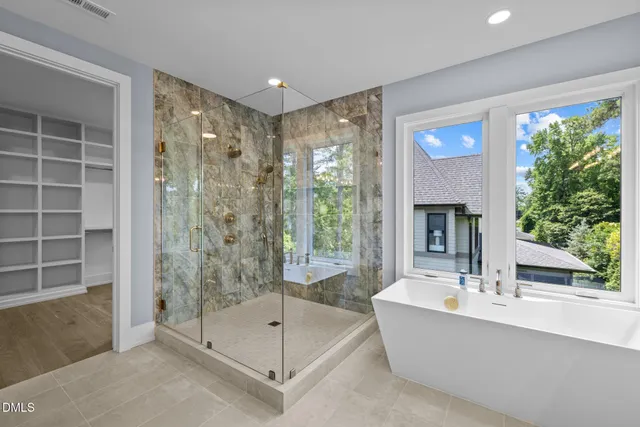 a bathroom with a tub a sink and shower