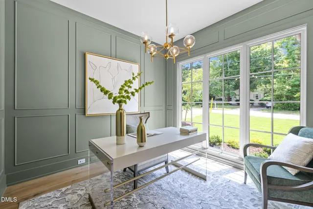 a living room with furniture a lamp and a potted plant