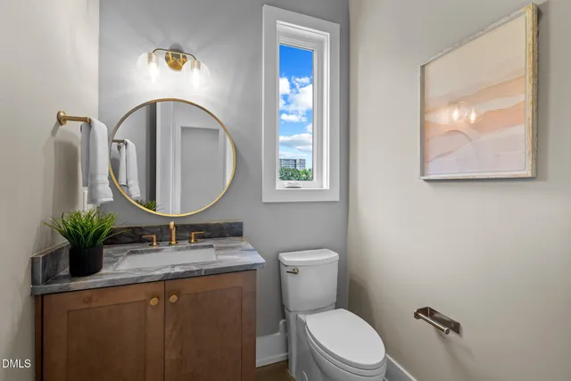 a bathroom with a toilet a sink and a mirror