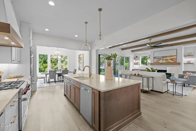 a kitchen with stainless steel appliances granite countertop a sink stove and wooden floor