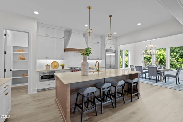 a large kitchen with a table and chairs