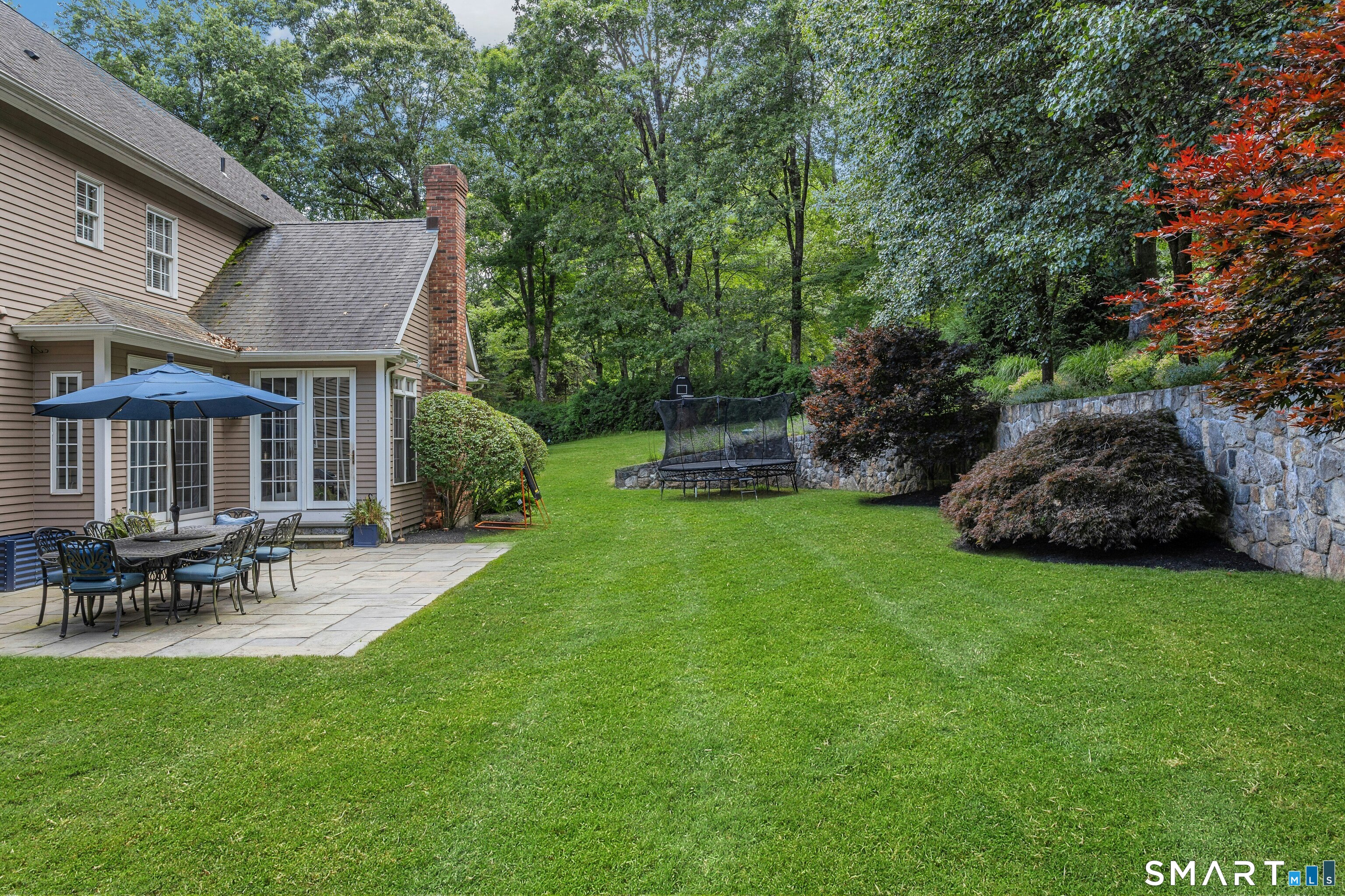 14 Turtle Ridge Court Ridgefield, CT 06877 - Photo 38 of 40 Serene Backyard with Stone Retaining Wall (Additional Property Above) & Mature Plantings With Irrigation