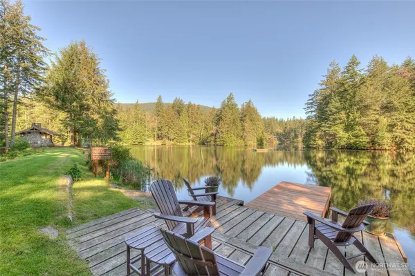 a view of a lake from balcony with furniture