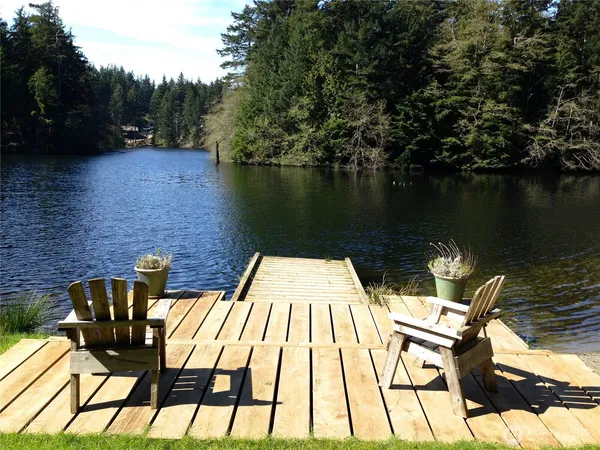 a view of swimming pool with seating space and lake view