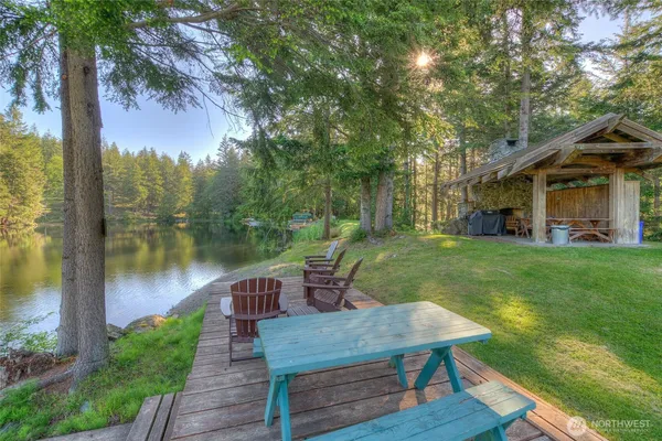 a view of a house with backyard and sitting area