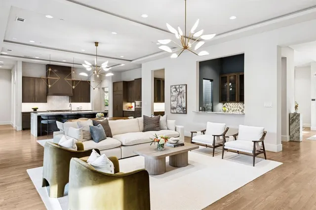 a living room with furniture and a chandelier