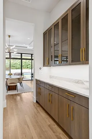 a living room with stainless steel appliances granite countertop a stove a sink and a large window
