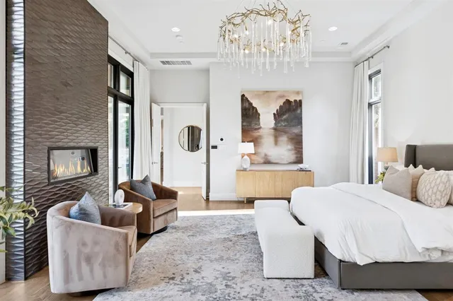 a spacious bedroom with a bed couch and window