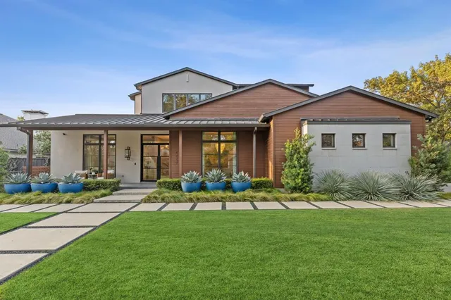 a front view of a house with a yard table and chairs