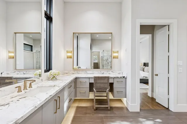 a spacious bathroom with a granite countertop sink and a mirror
