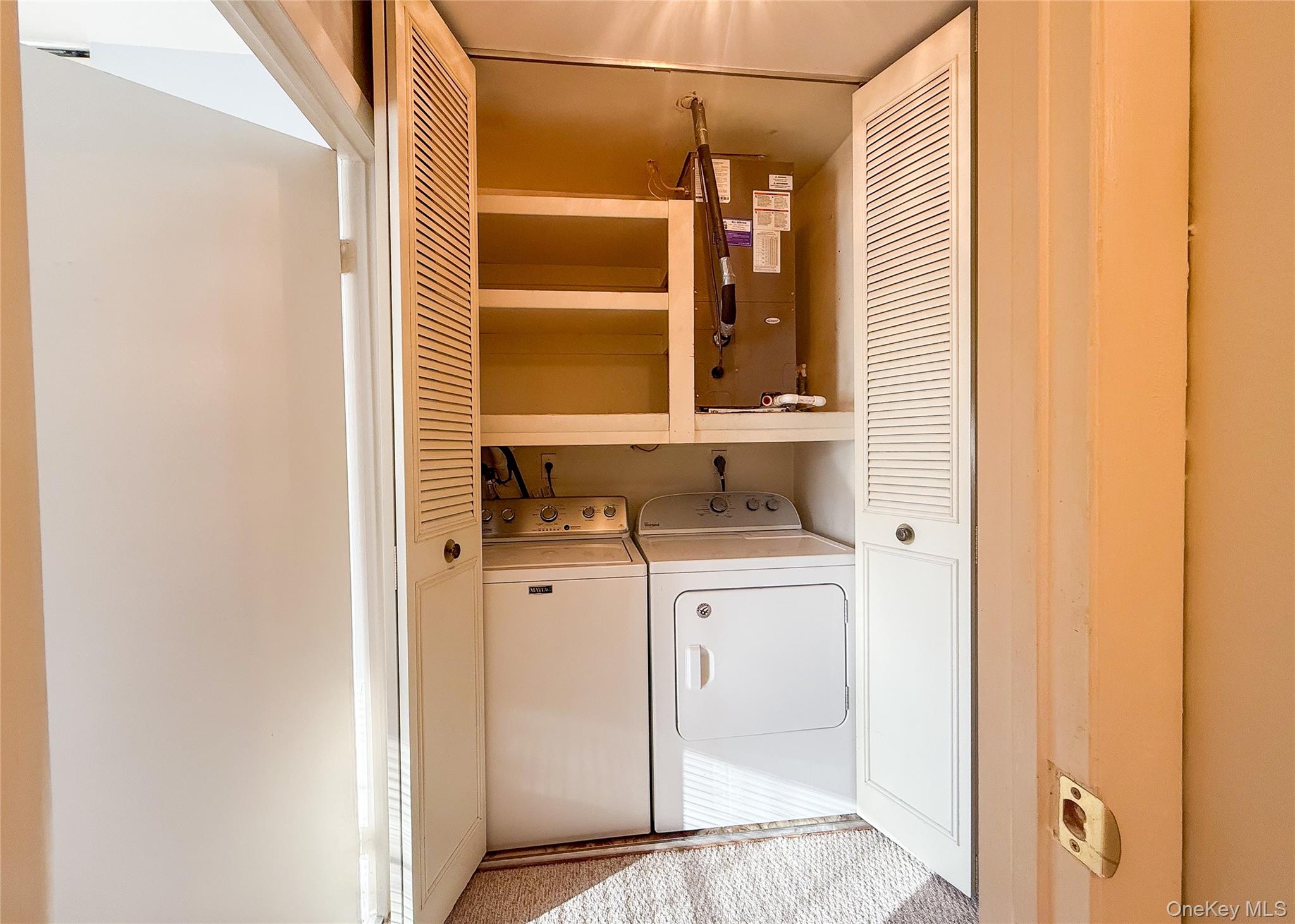 423 Woodbridge Drive, Unit B Ridge, NY 11961 - Photo 11 of 13 Washroom featuring washer and clothes dryer and heating unit
