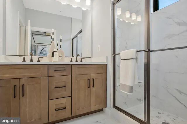 a bathroom with a double vanity sink and mirror