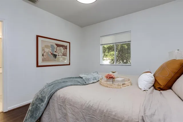 a bedroom with a bed and a chair