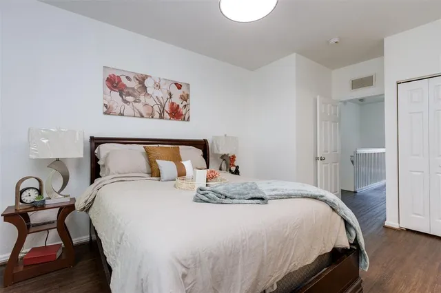 a bedroom with bed and painting on the wall