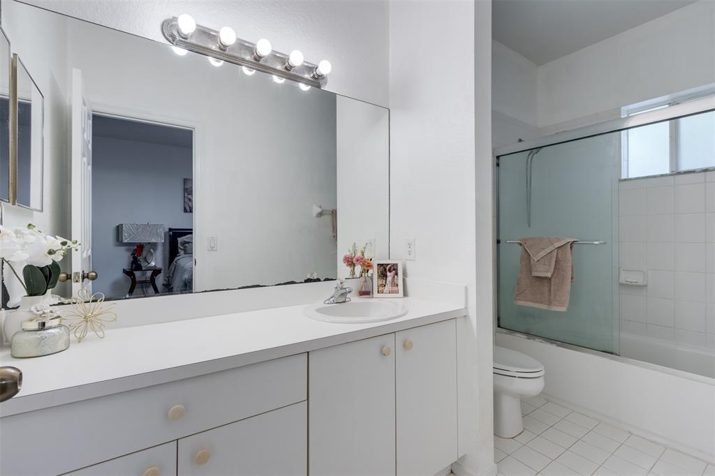 5545 Monte Carlo Place, Unit 5545 Margate, FL 33068 - Photo 19 of 41 a bathroom with a sink a toilet and a mirror