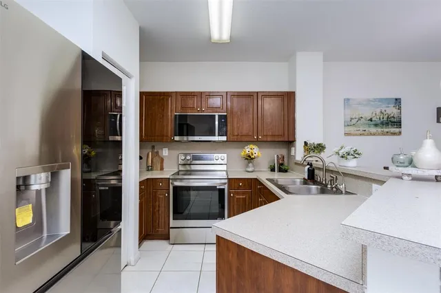 a kitchen with a sink a stove and refrigerator