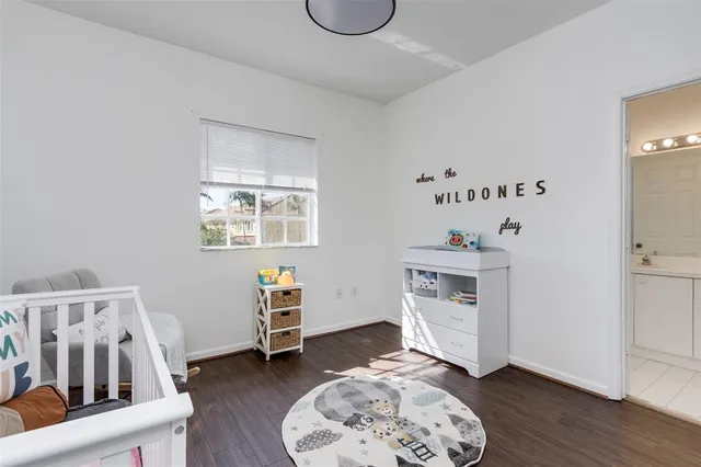 a room with a baby crib and a chair