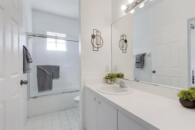 a bathroom with a sink vanity and a mirror