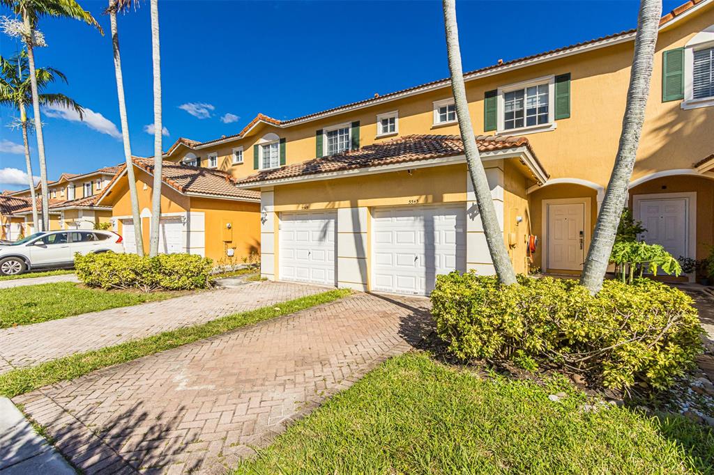 5545 Monte Carlo Place, Unit 5545 Margate, FL 33068 - Photo 30 of 41 a front view of a house with a garden