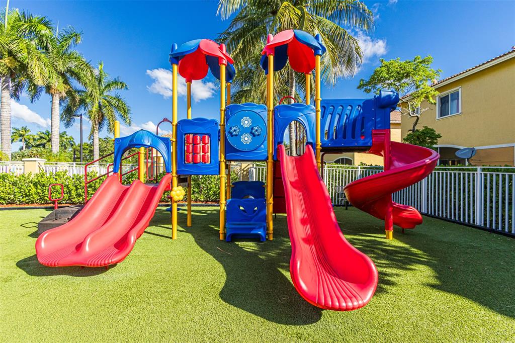 5545 Monte Carlo Place, Unit 5545 Margate, FL 33068 - Photo 39 of 41 a view of a park with a slide and potted plants