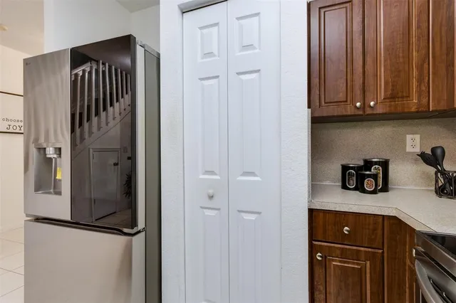 a kitchen with a refrigerator and cabinets