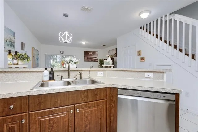 a kitchen with a sink and a refrigerator