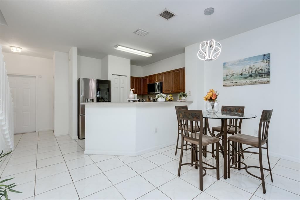 5545 Monte Carlo Place, Unit 5545 Margate, FL 33068 - Photo 7 of 41 a view of kitchen and dining area with furniture