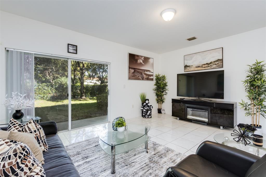 5545 Monte Carlo Place, Unit 5545 Margate, FL 33068 - Photo 9 of 41 a living room with furniture and a flat screen tv