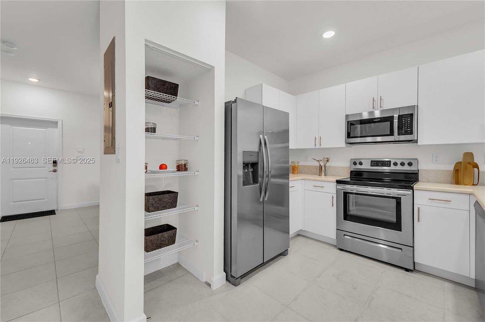 12976 Southwest 233rd Terrace Homestead, FL 33032 - Photo 13 of 27 a kitchen with cabinets and stainless steel appliances