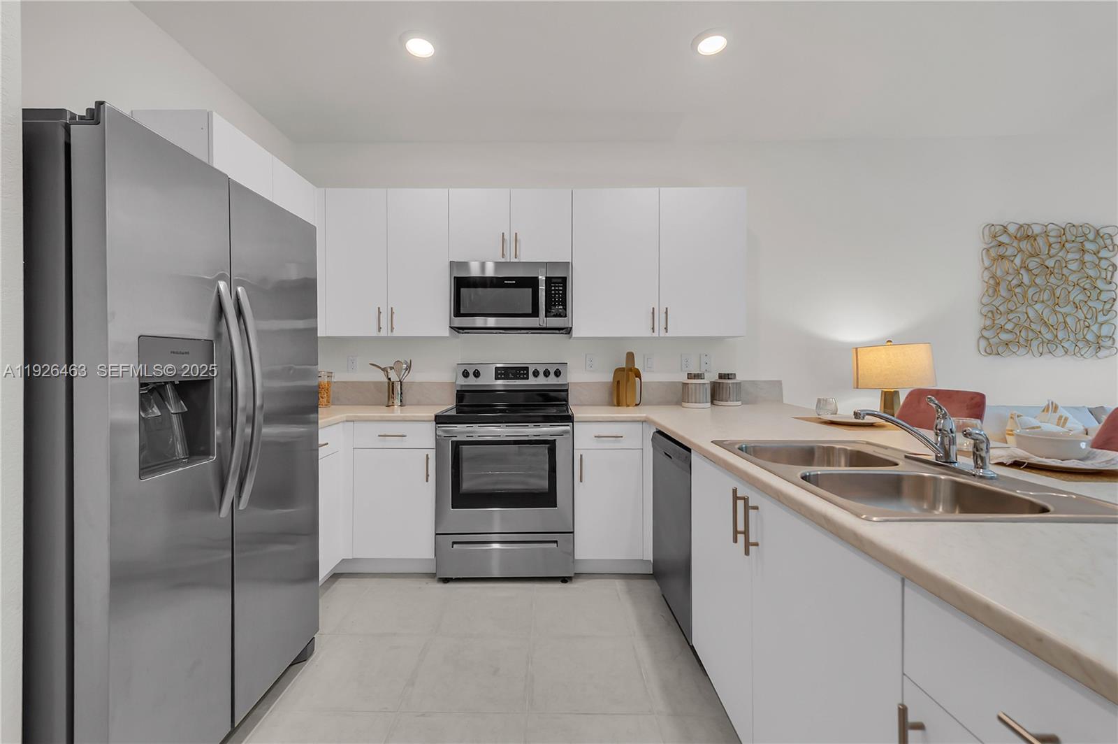 12976 Southwest 233rd Terrace Homestead, FL 33032 - Photo 14 of 27 a kitchen with stainless steel appliances a refrigerator sink and microwave