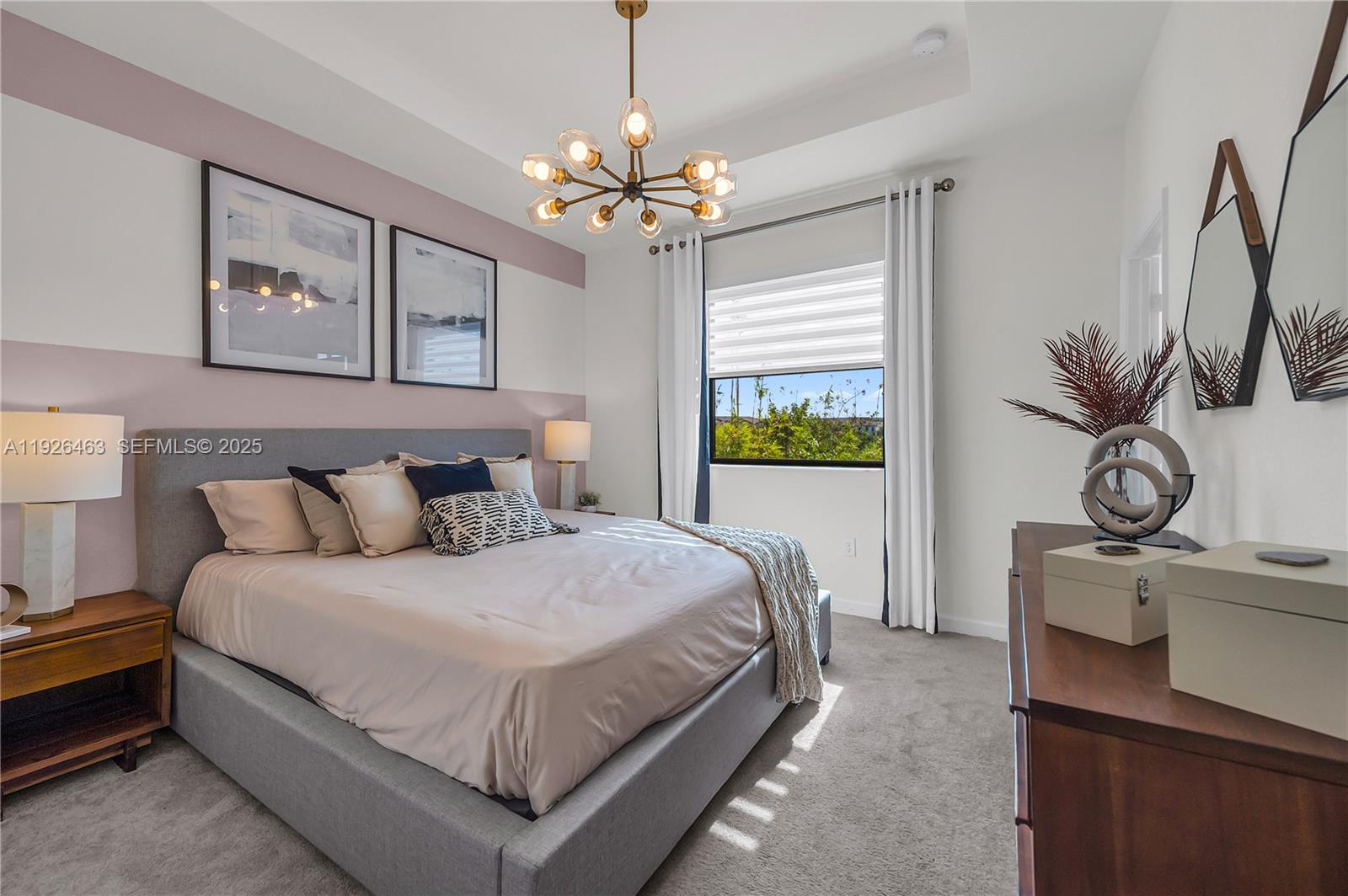 12976 Southwest 233rd Terrace Homestead, FL 33032 - Photo 17 of 27 a bedroom with a bed and a chandelier