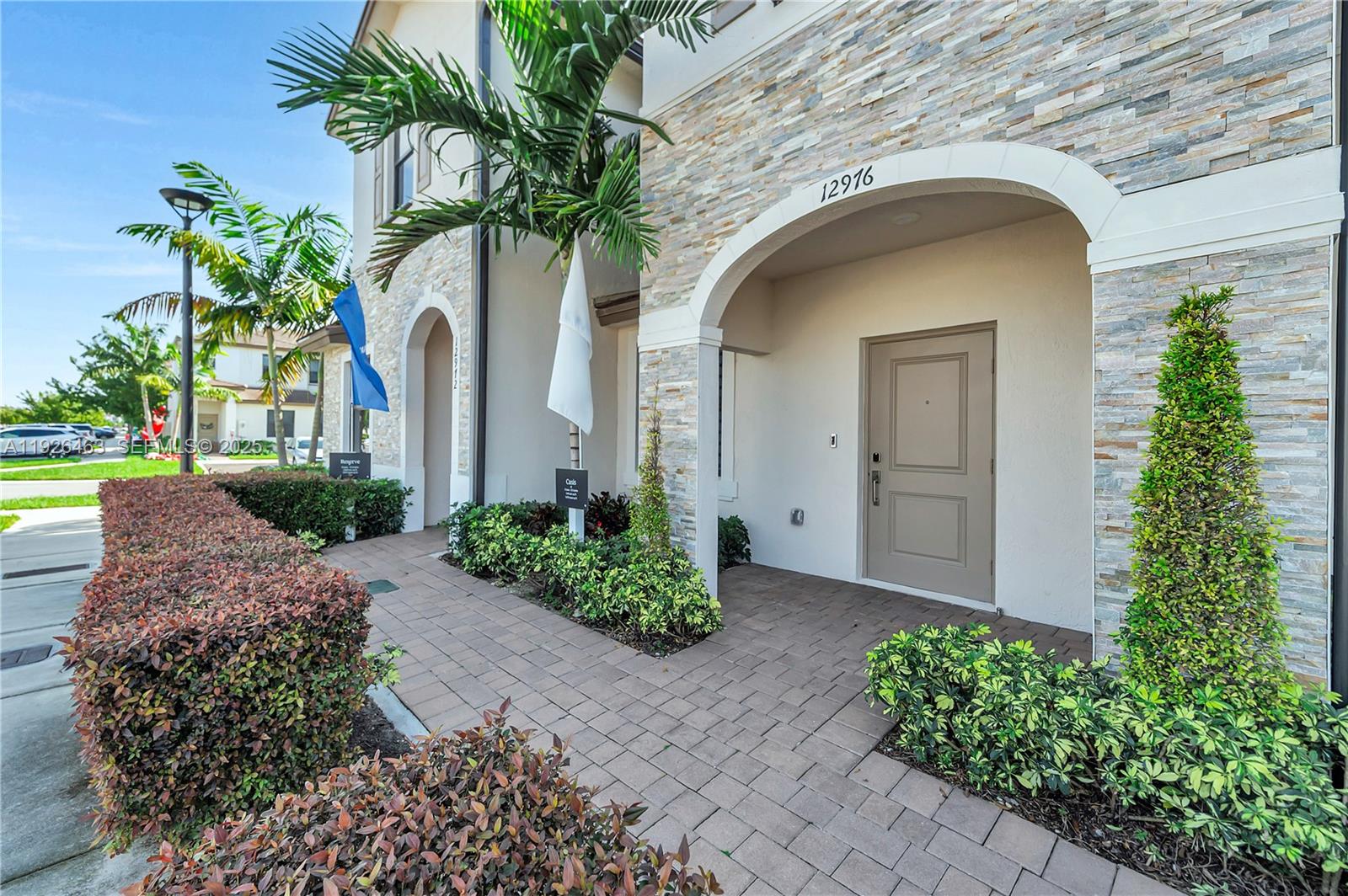 12976 Southwest 233rd Terrace Homestead, FL 33032 - Photo 2 of 27 a front view of a house with garden