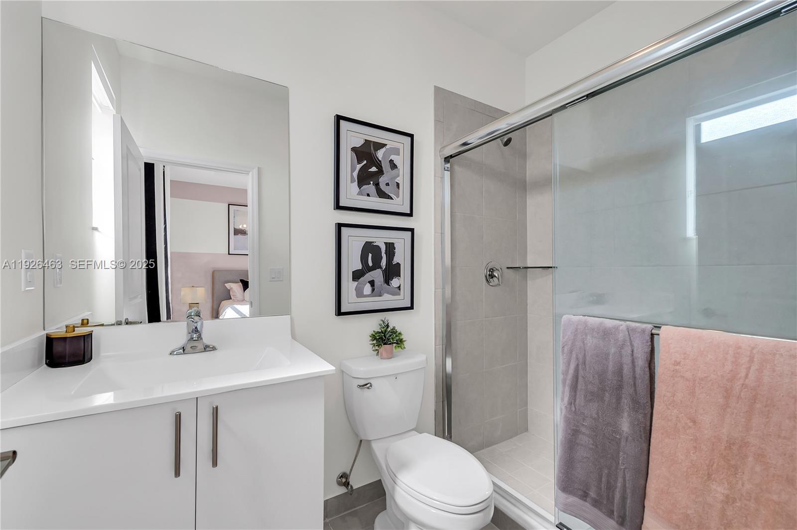 12976 Southwest 233rd Terrace Homestead, FL 33032 - Photo 21 of 27 a bathroom with a sink a toilet a mirror and shower