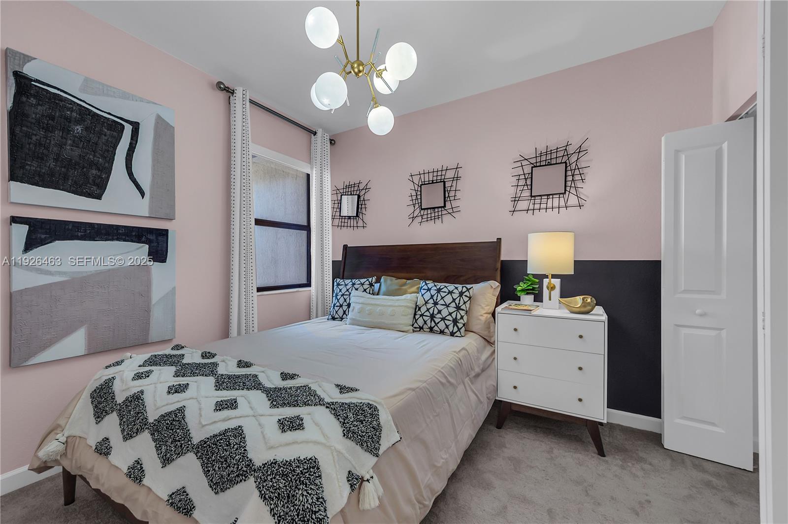 12976 Southwest 233rd Terrace Homestead, FL 33032 - Photo 24 of 27 a bedroom with a bed and a chandelier