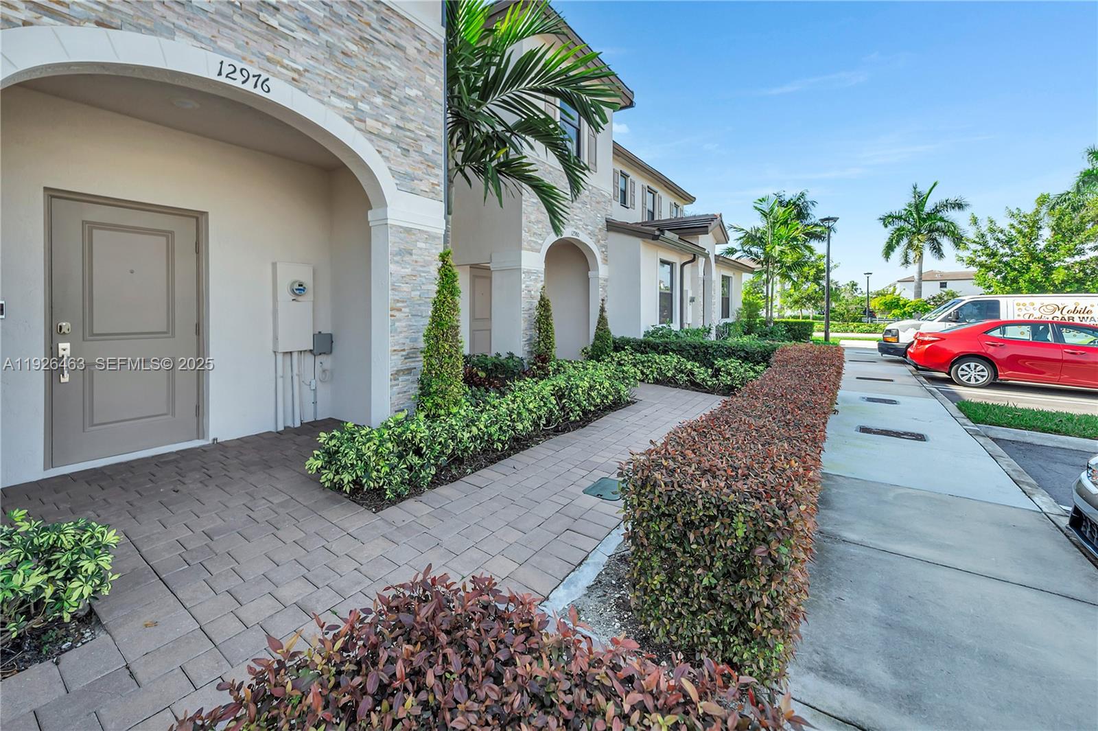 12976 Southwest 233rd Terrace Homestead, FL 33032 - Photo 3 of 27 a front view of a house with a yard