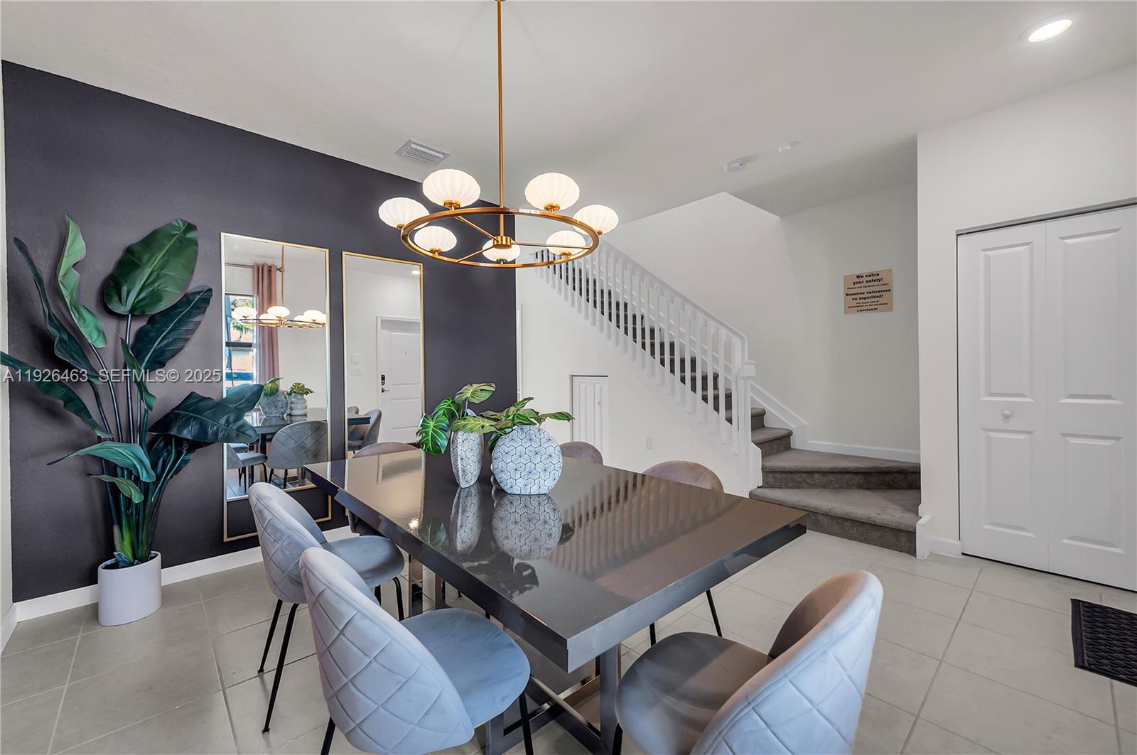 12976 Southwest 233rd Terrace Homestead, FL 33032 - Photo 6 of 27 a view of a dining room with furniture wooden floor and chandelier