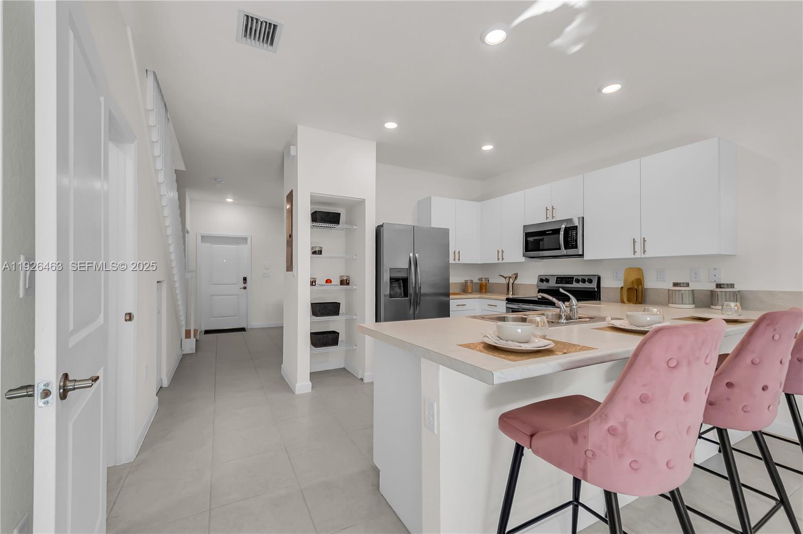 12976 Southwest 233rd Terrace Homestead, FL 33032 - Photo 8 of 27 a kitchen with stainless steel appliances a refrigerator sink and cabinets