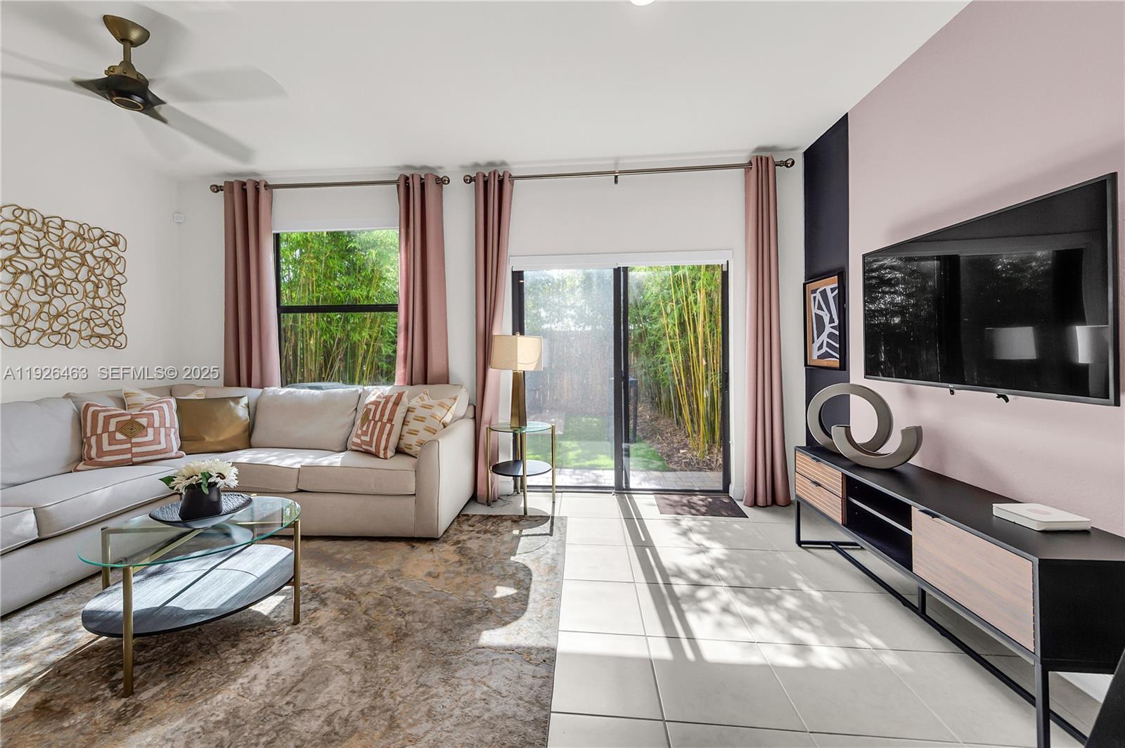 12976 Southwest 233rd Terrace Homestead, FL 33032 - Photo 10 of 27 a living room with furniture and a flat screen tv