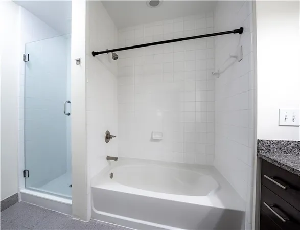 a bathroom with a granite countertop sink and a toilet