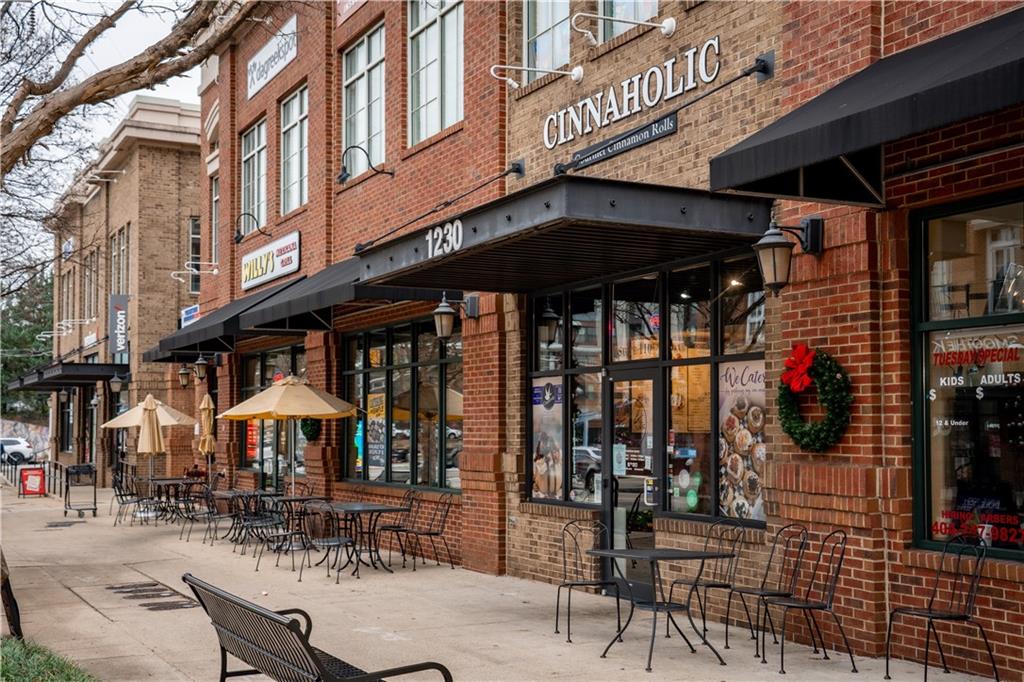 1221 Caroline Street Northeast, Unit 208 Atlanta, GA 30307 - Photo 18 of 26 a view of a cafe with a table and chairs under an umbrella