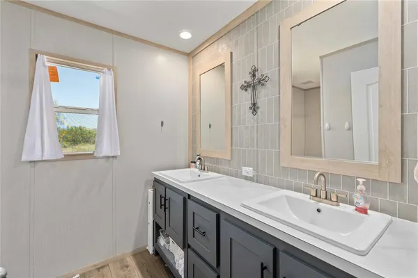 a bathroom with a sink and a mirror