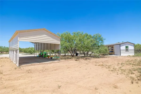 a view of a outdoor space with green field and trees