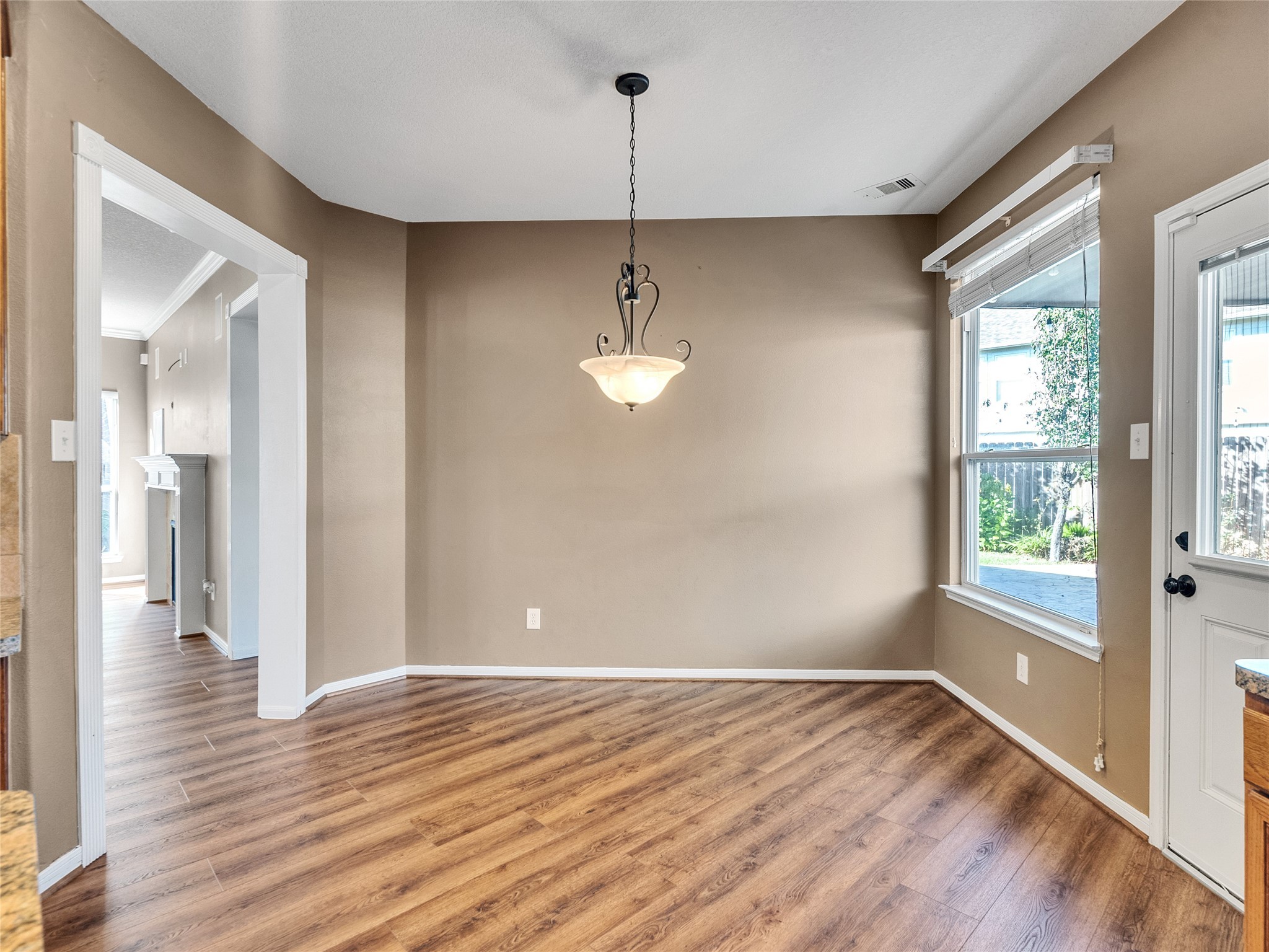 9915 Valance Way Conroe, TX 77385 - Photo 12 of 31 a view of empty room with wooden floor and fan
