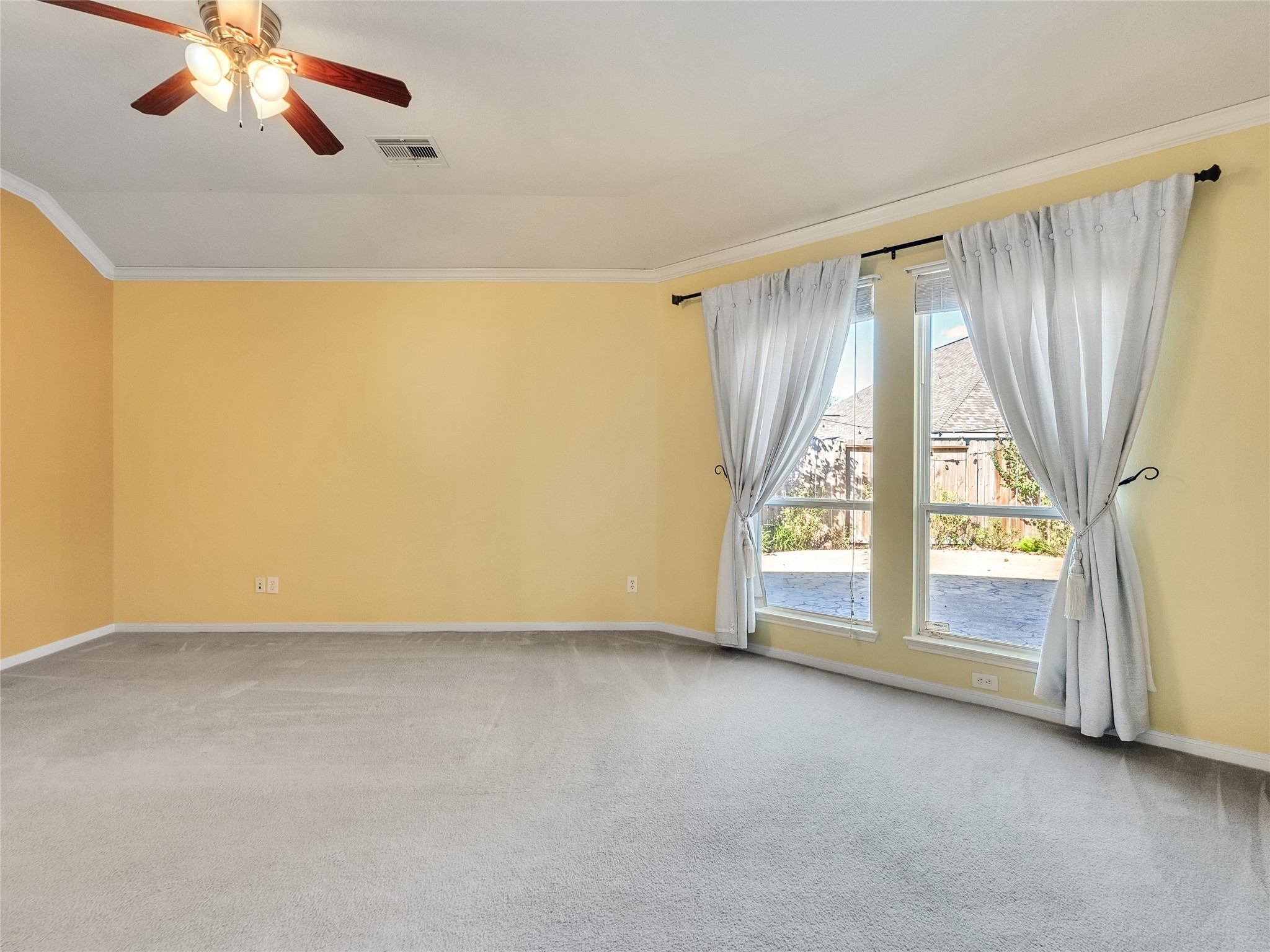 9915 Valance Way Conroe, TX 77385 - Photo 13 of 31 a view of an empty room with chandelier fan and fire place