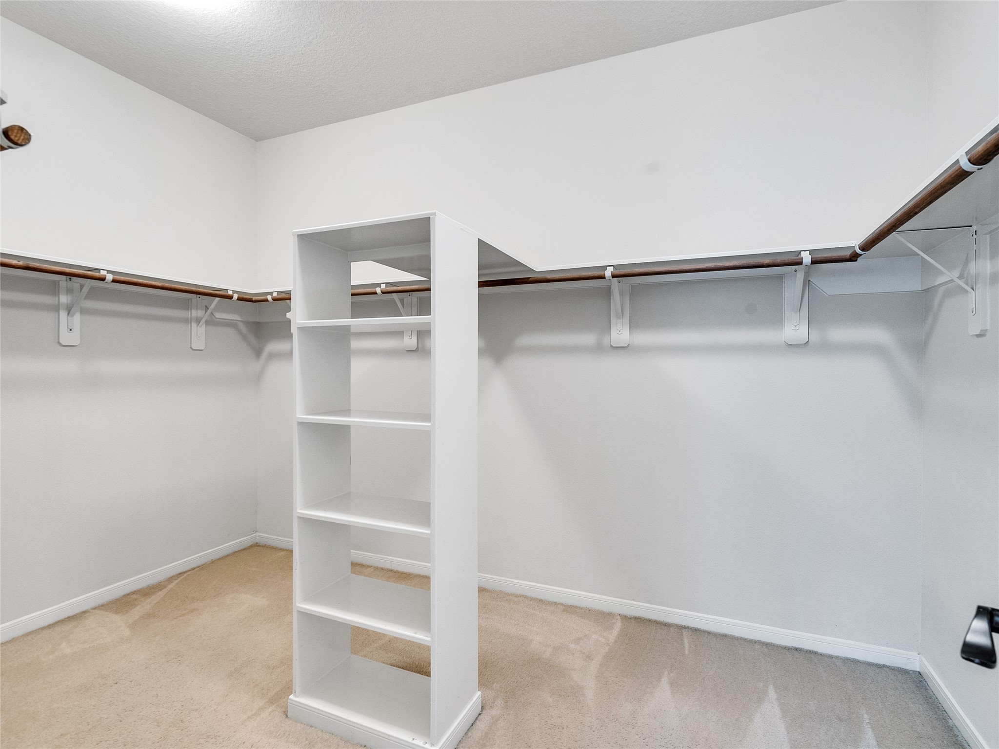 9915 Valance Way Conroe, TX 77385 - Photo 17 of 31 a view of an empty walk in closet