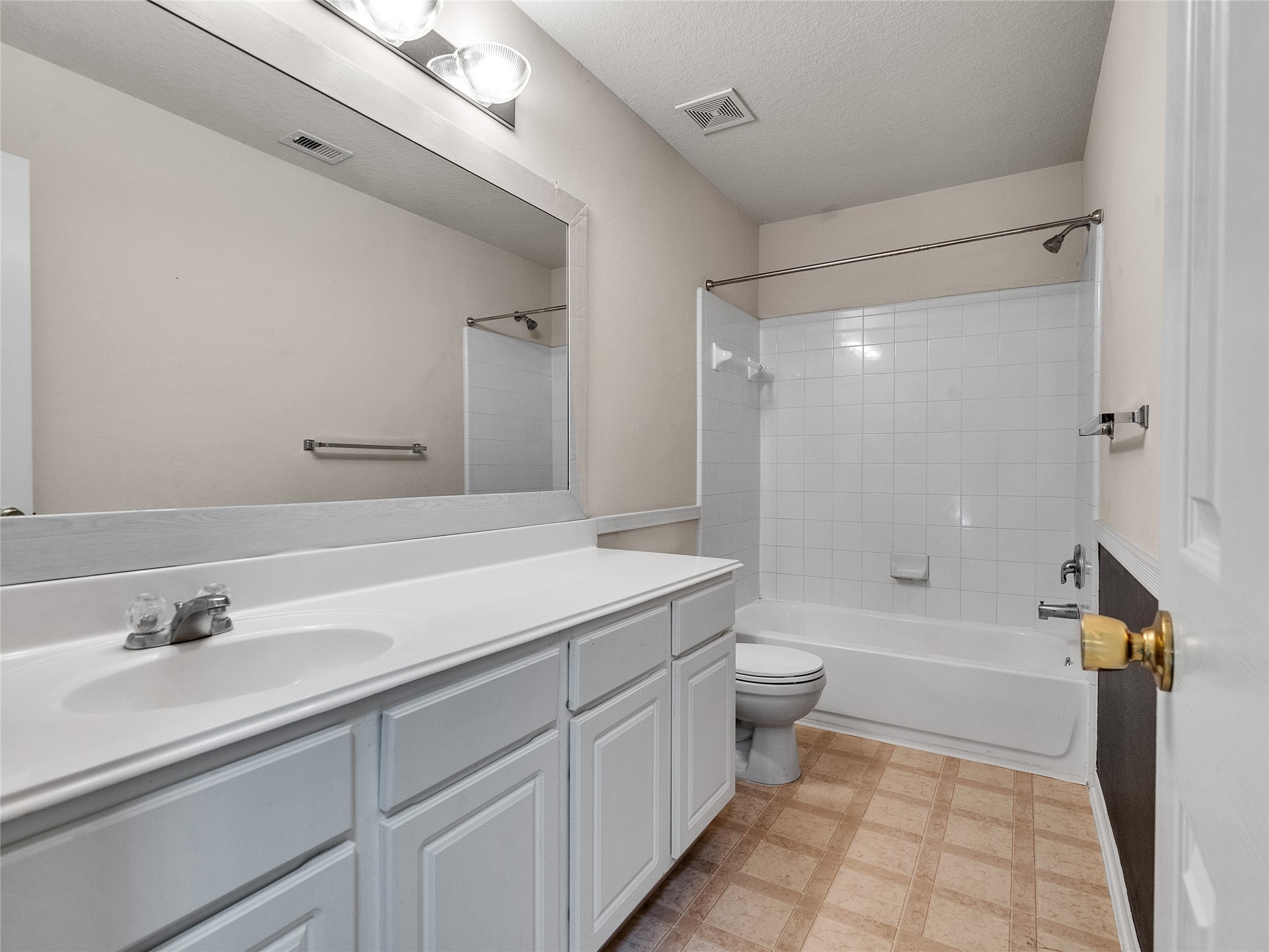 9915 Valance Way Conroe, TX 77385 - Photo 26 of 31 a bathroom with a sink a toilet and a large mirror