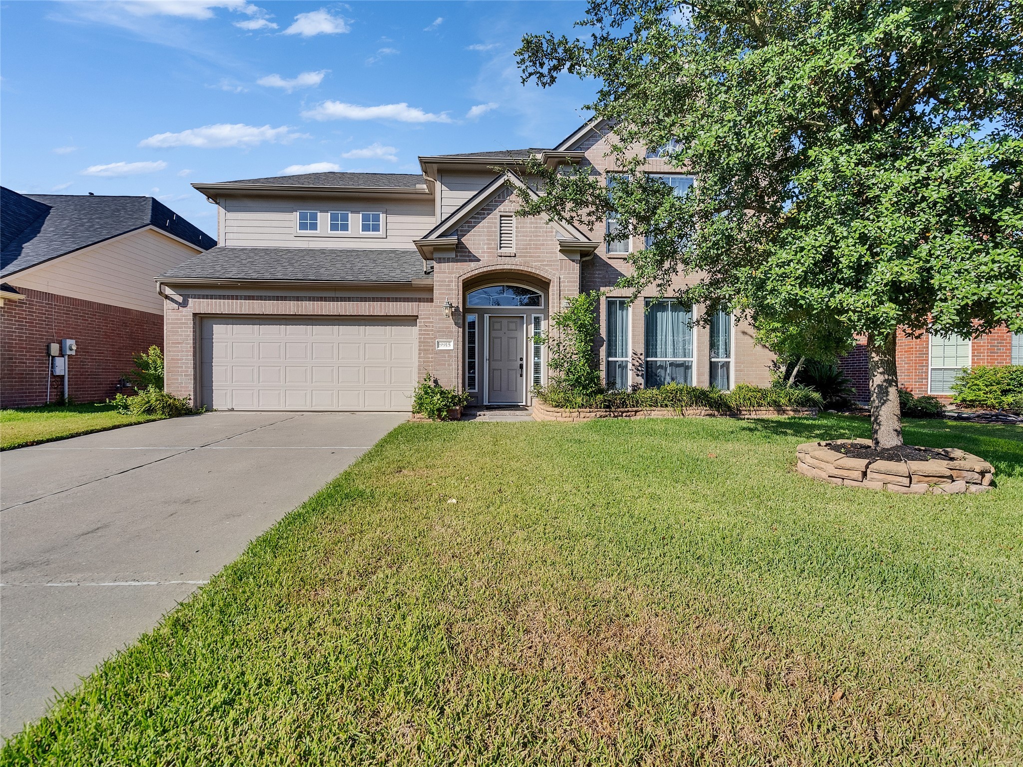 9915 Valance Way Conroe, TX 77385 - Photo 3 of 31 a front view of a house with a yard and garage