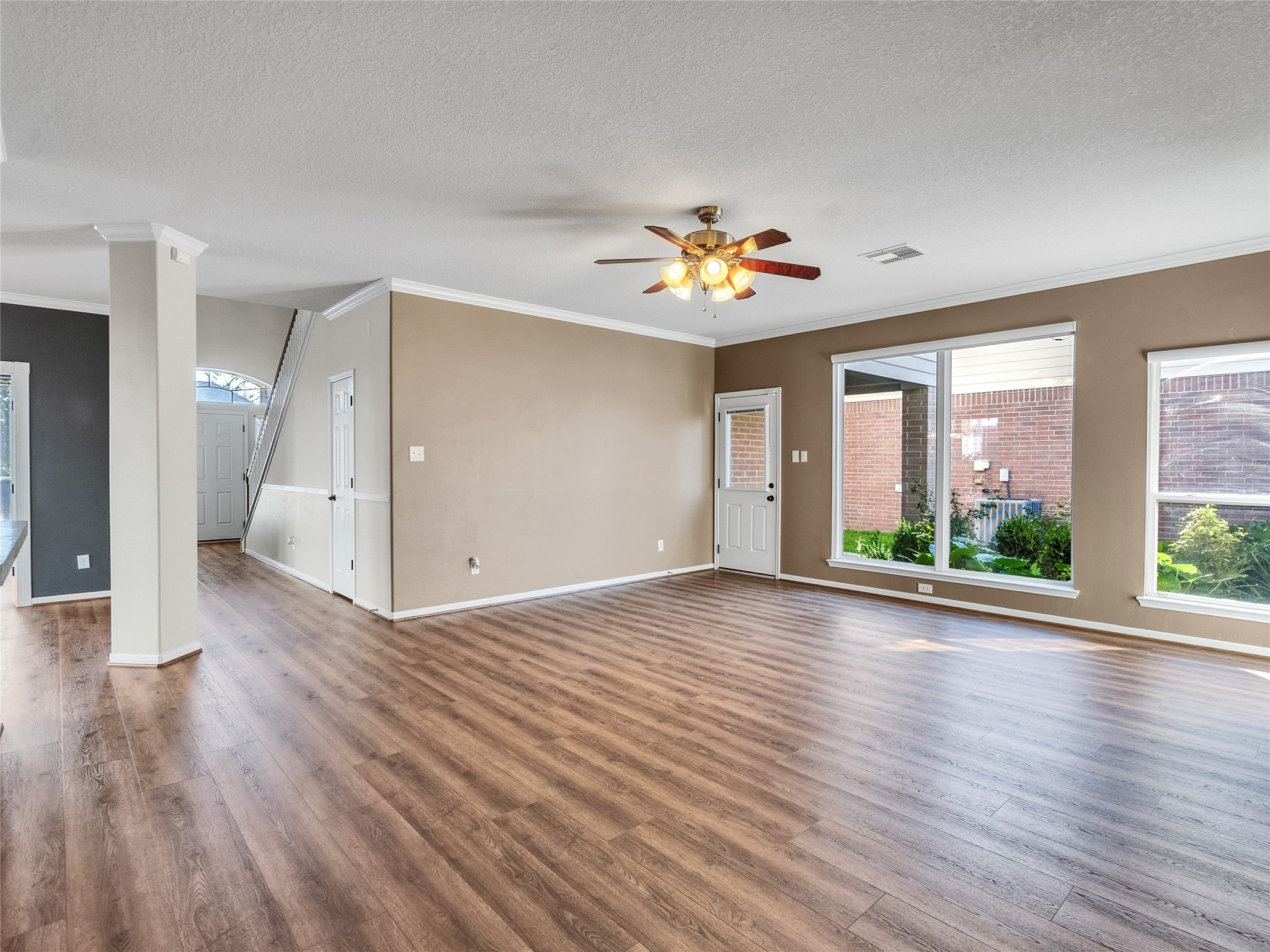 9915 Valance Way Conroe, TX 77385 - Photo 4 of 31 a view of an empty room with a window and wooden floor