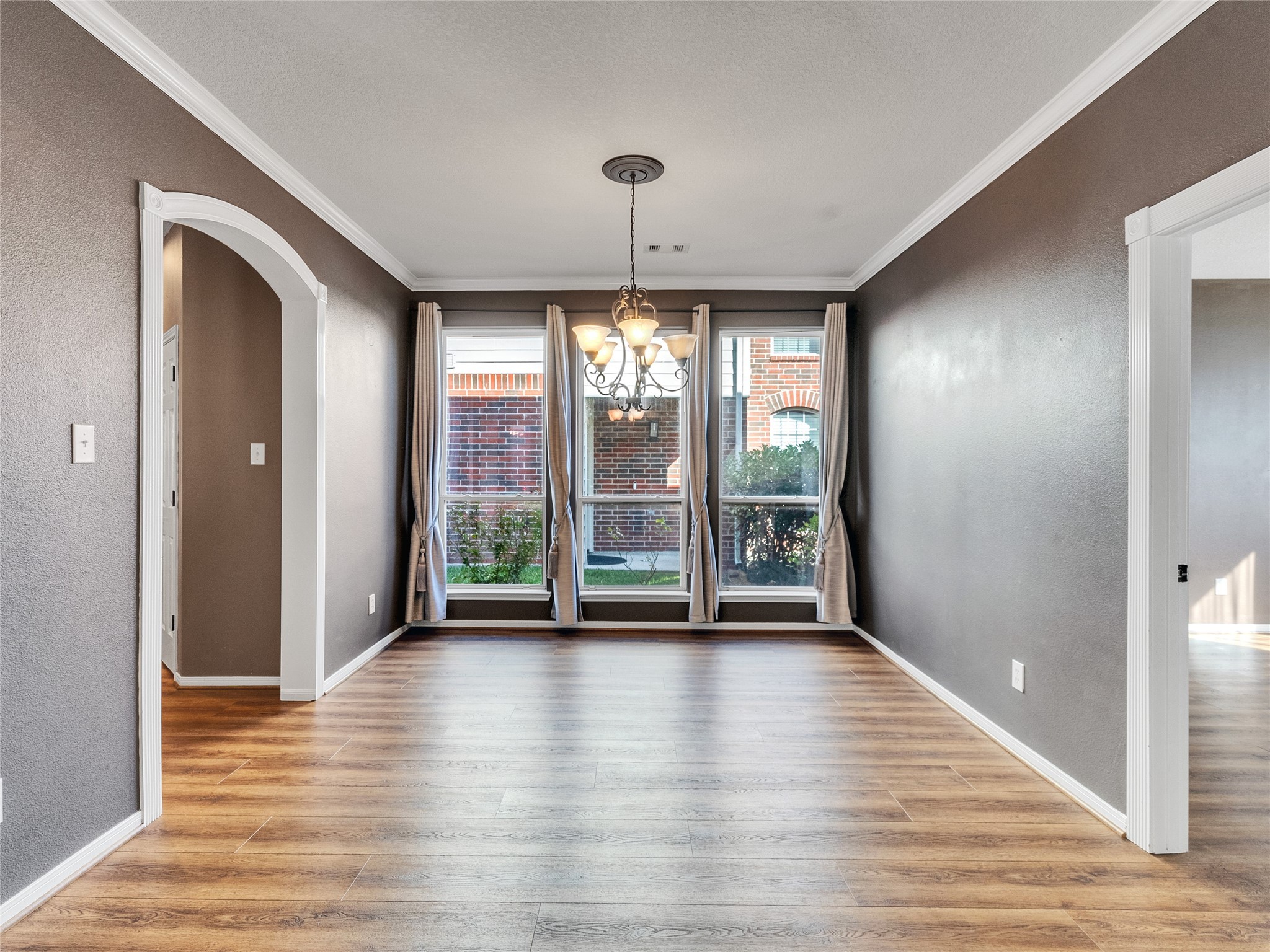 9915 Valance Way Conroe, TX 77385 - Photo 8 of 31 a view of an empty room with wooden floor and a window